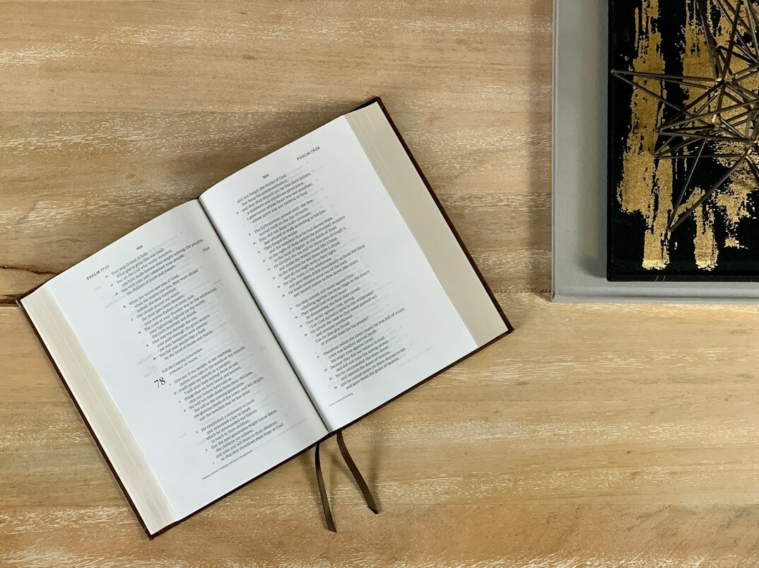 Open old books with handwritten notes on a table
